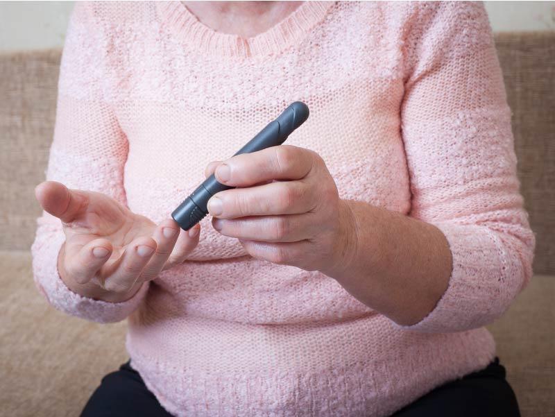 Diabetic woman testing blood sugar.